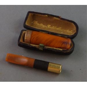 Cigar holder with a 9ct gold band, in original box together…
