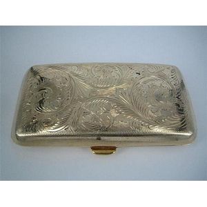 A silver-gilt cigarette case with engraved decoration. 9.3 x 5.…