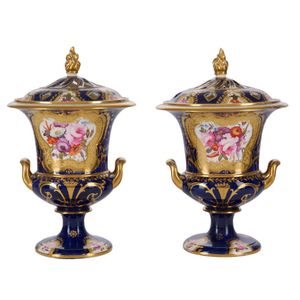 A pair of English porcelain lidded urns, first half 19th…