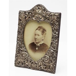 A sterling silver photograph frame with heart shape aperture…