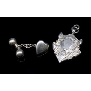 Antique silver fob medal and a single cufflink the heart…