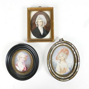 Three hand painted portrait miniatures, two on ivory, one on…
