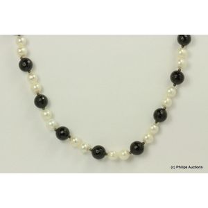 A strand of pearls and onyx. Sterling silver set, strung as an…