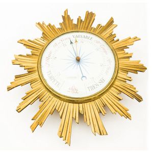 A starburst barometer, in a brass case housing an enamelled dial