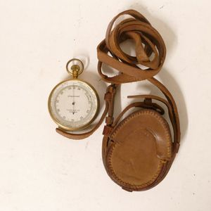 A gilt metal cased aneroid pocket barometer, silver dial marked…