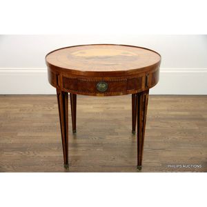 An antique tulipwood drum style salon games table, late 19th…