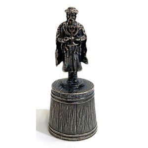 A silver metal candle snuffer, gentleman holding a Menorah,…