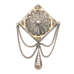 A silver metal filigree diamond shape brooch, drop chain drops ...