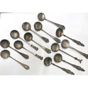 Thirteen silver metal spoons with coin bowls with unverified…