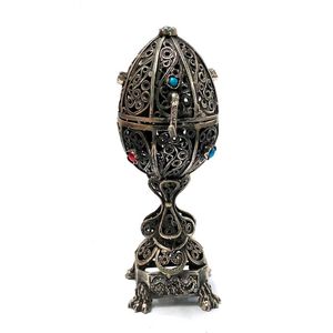 A silver metal filigree egg with lion & turquoise, coral detail…