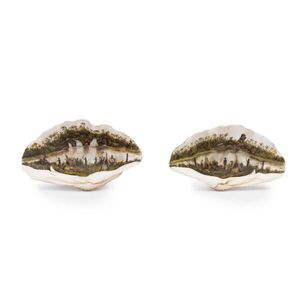 A pair of rare and important hand painted clam shells depicting…