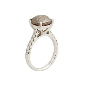 Cognac diamond ring. Centring a claw-set brilliant-cut cognac&hellip;