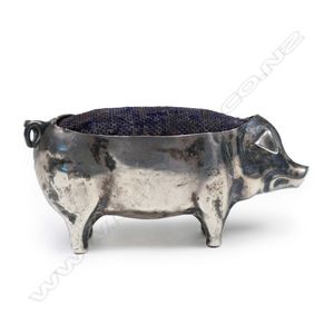 An Edwardian silver pig pin cushion, original cushion back.…