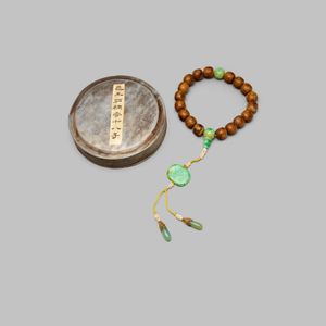 An aloeswood and jade beaded rosary with a pewter box, each…