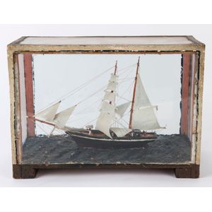 A folk art model ship in cabinet, 19th century, 28 cm high, 40…