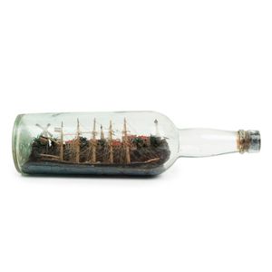 An antique clipper ship in a bottle set in fine diorama harbour…