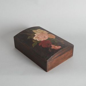 An antique jewellery box, made from wood with a quilted fabric…