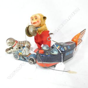 2 tin plate wind up toys; rocket ship -. Bug eyes and cat with…