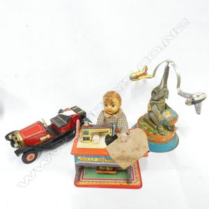Thre tin plate toys; 1 battery operated Dolly Dressmaker…