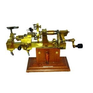 A Victorian brass watchmaker's lathe, hand operated with ebony…