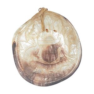 A carved mother of pearl shell, carved with the Australian coat…