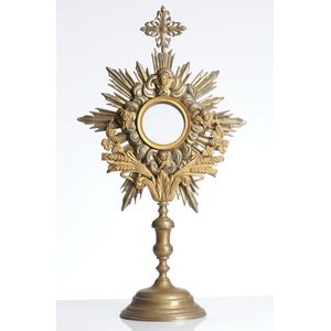 An embossed brass monstrance, late 19th century, the central…