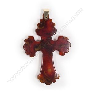 A c1900 carved amber cross, swollen lobed ends, displaying good…