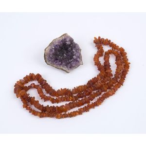 A graduated raw amber necklace and geode crystal sample, early…