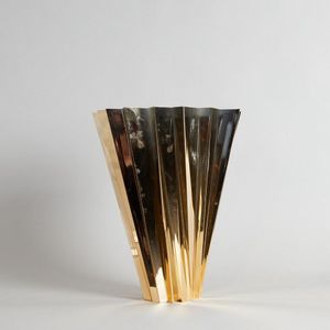 A Shanghai vase by Mario Bellini for Kartell, in glossy gold.…