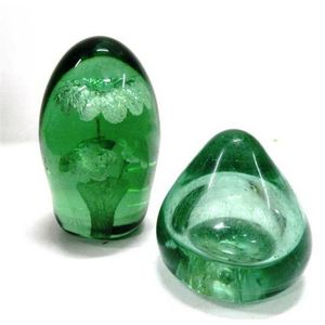 A 19th century green glass dump paperweight, foil flowers in…