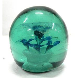 A 19th century green glass dump paperweight, blue flowers in…