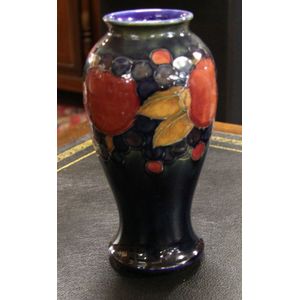 A Moorcroft Pomegranate Design Vase On A Deep Blue Ground