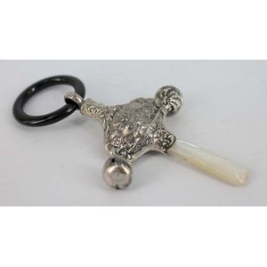 A silver baby's rattle with mother-of-pearl handle and onyx…