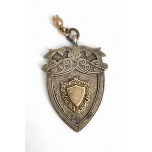 An antique sterling silver medal, heightened in rose gold plate,…