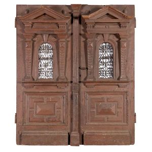 A pair of large wrought iron mounted and carved panelled doors,…