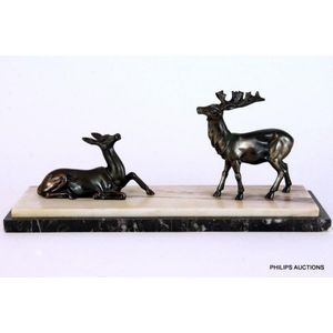 An Art Deco spelter deer group, depicting a recumbent doe and a…