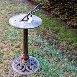 A cast iron sun dial. The hexagonal column on a pierced base.…
