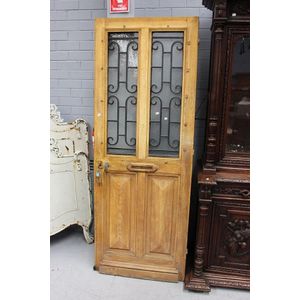 Old French entrance door, with iron grill and letter slot