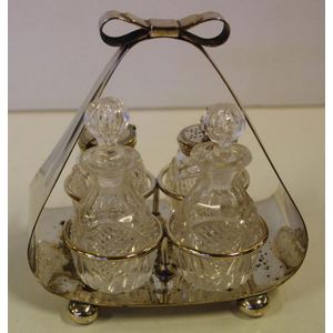 Silver plate bow basket cruet set, with 4 crystal bottles