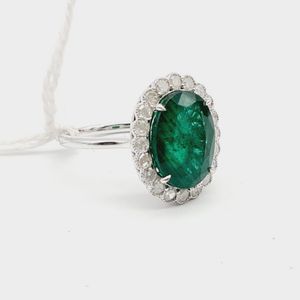 14ct white gold emerald and diamond halo ring, featuring centre,…