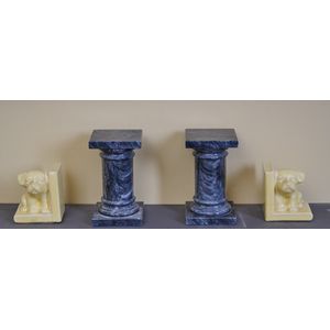 A pair of bookends and a pair of decorative columns, the…