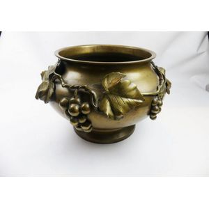 A French bronze jardiniere featuring an applique decoration of…