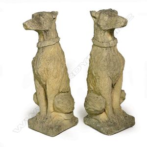 A pair of church stone classical seated hound dogs their backs…