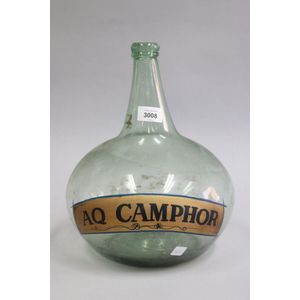 Antique green onion bottle, AQ Camphor, showing remnants of…