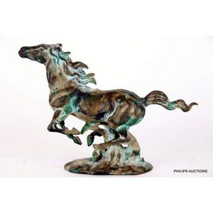 A cast iron horse with a distressed painted finish, the…