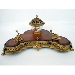 A wooden Inkstand with gilded features and a porcelain painted…