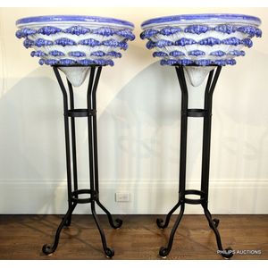 Two impressive Italian glazed ceramic urns on stands, broad…