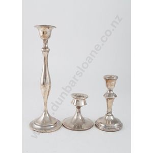 Three various sterling silver candlesticks comprising one…