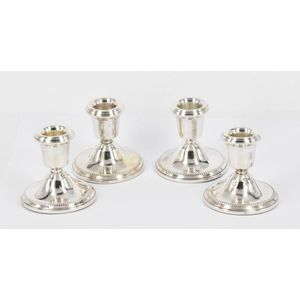 A set of four sterling silver candlesticks, weighted, W I…
