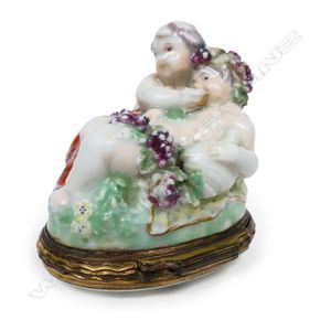 A George III porcelain and enamel cherub snuff box, the two…